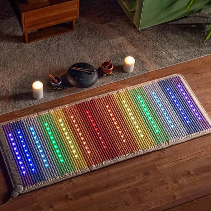 HealthyLine Rainbow Chakra PEMF Far Infrared Heating Mat with colorful lights on a wooden floor.