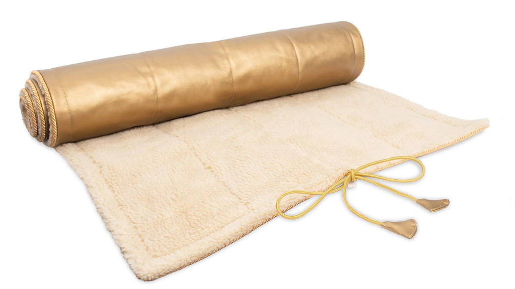 Holistic Silk luxury Yoga Rug Mat rolled out, featuring a golden top and soft beige underside with ties.