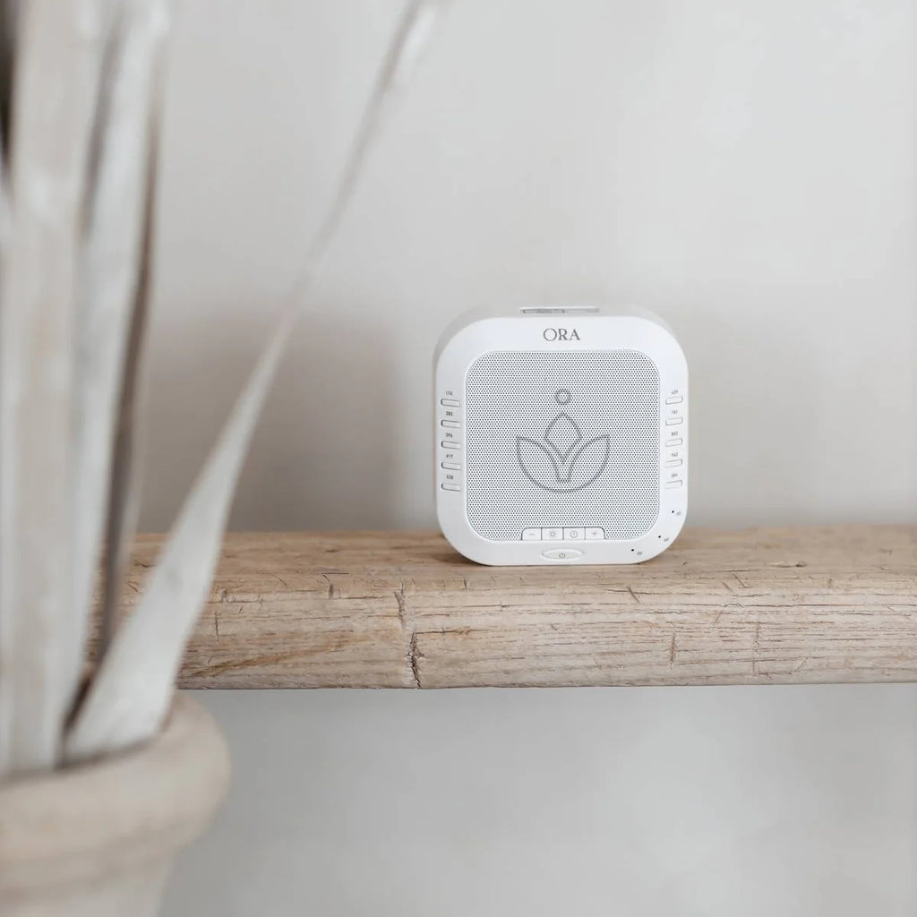 ORA Sound Frequency Machine on wooden shelf designed for calming sound therapy and relaxation.