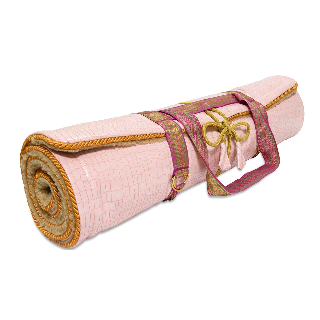 Holistic Silk luxury Yoga Rug Mat rolled up with a vibrant strap, perfect for yoga enthusiasts.