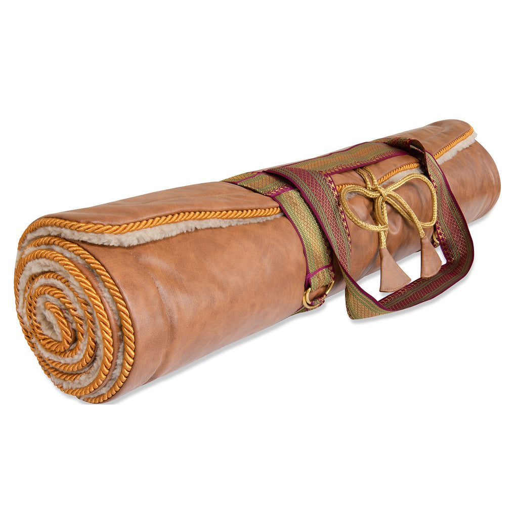 Holistic Silk luxury yoga rug mat rolled up with elegant design and carrying strap.