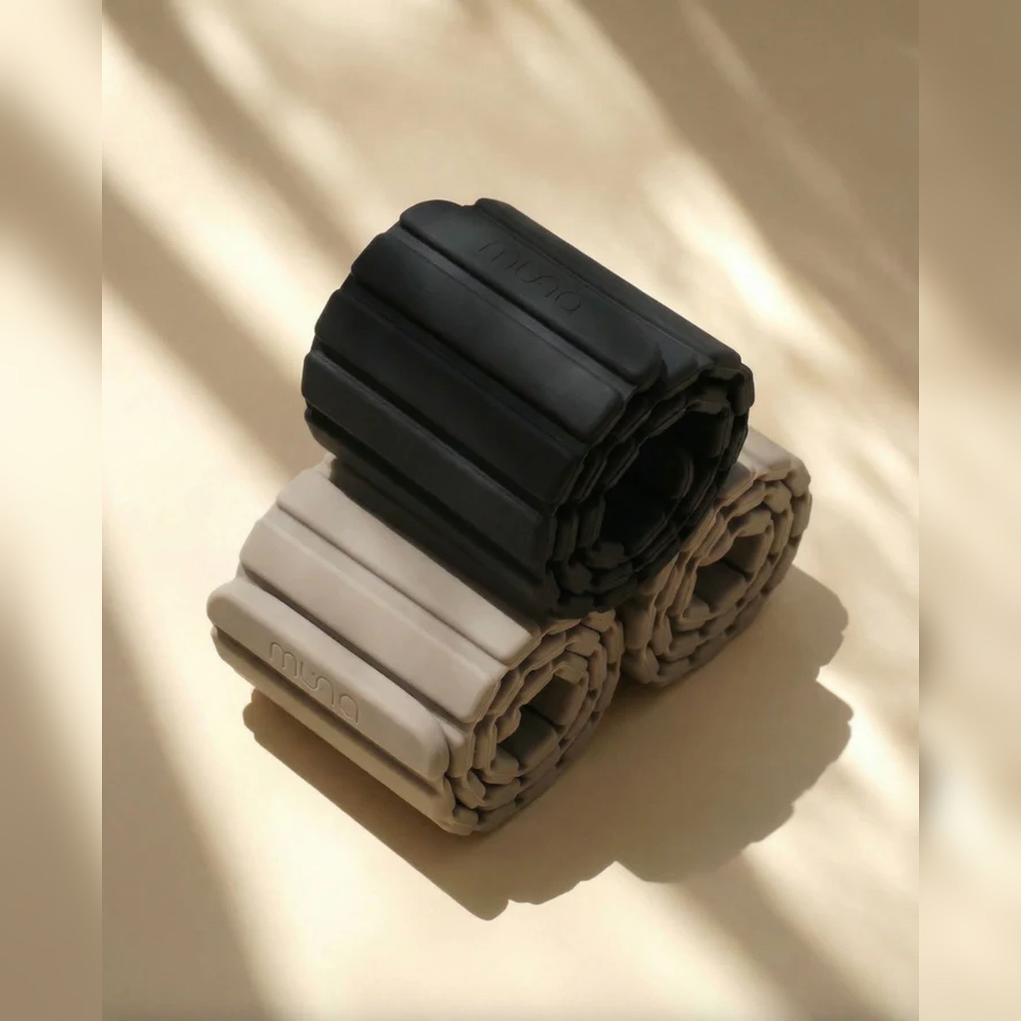 Muna Magnetic Ankle Wrist Weight in black and beige colors, designed for resistance training and low-impact exercises.