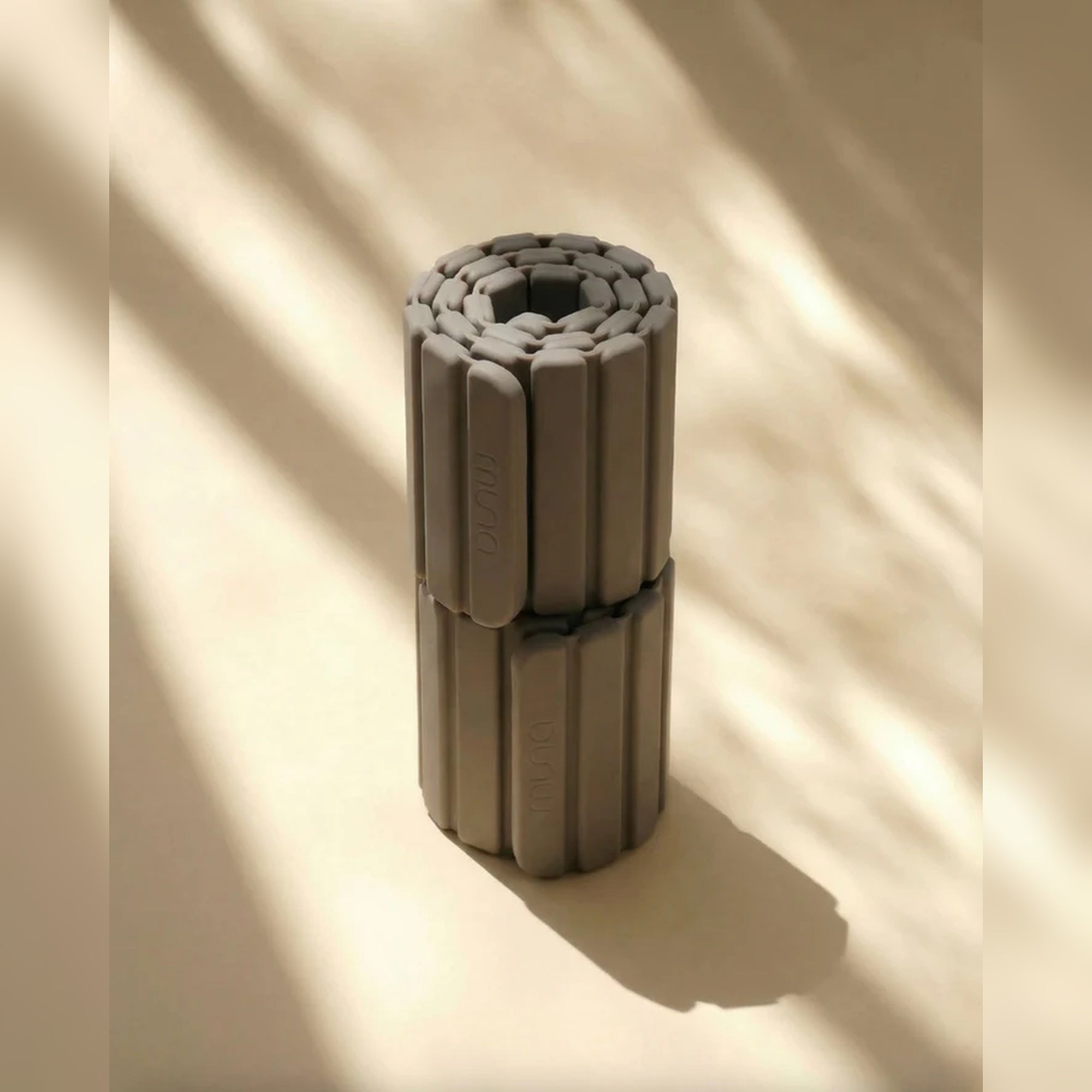 Muna Magnetic Ankle Wrist Weight rolled up, showcasing its innovative design for resistance training.