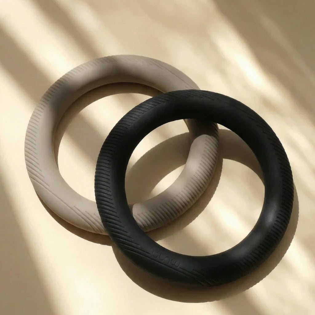 Muna Dumbbell Ring in two colors, showcasing unique ring design for versatile grip and enhanced control in workouts.