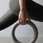 Person using the MUNA Dumbbell Ring during a workout session for enhanced upper-body control.